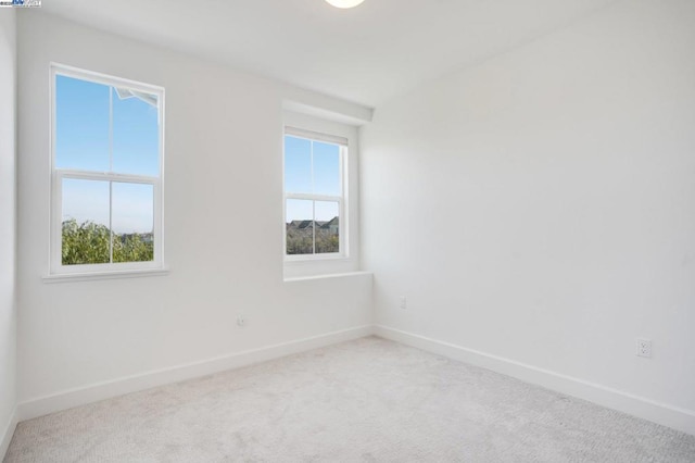 carpeted spare room with a healthy amount of sunlight