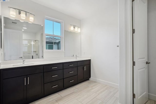 bathroom with vanity and a shower with shower door