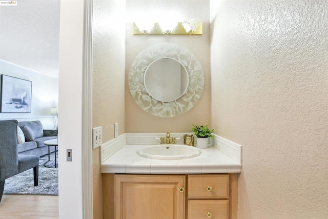 bathroom with vanity and hardwood / wood-style floors