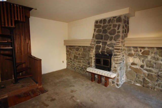 unfurnished living room with dark carpet and a fireplace