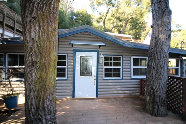 property entrance with a deck