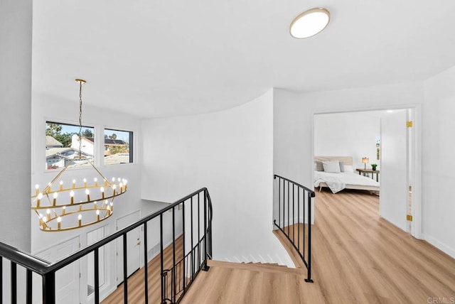 hall with a chandelier and light hardwood / wood-style floors