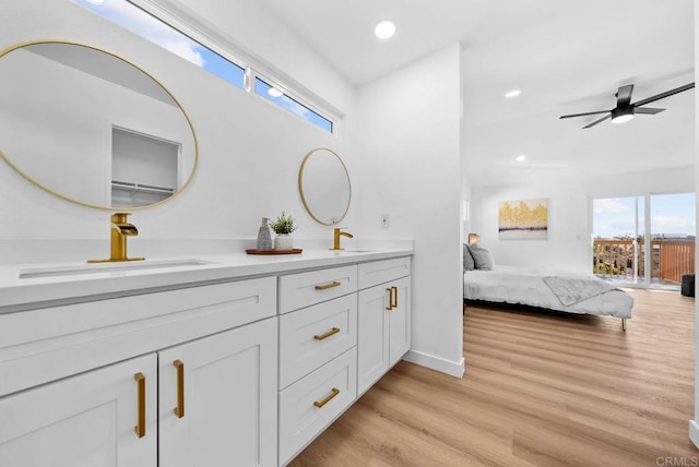 bathroom featuring hardwood / wood-style flooring, vanity, and ceiling fan