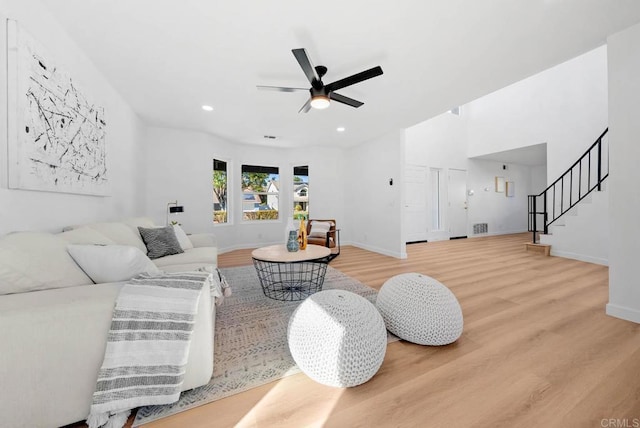 living room featuring hardwood / wood-style floors and ceiling fan