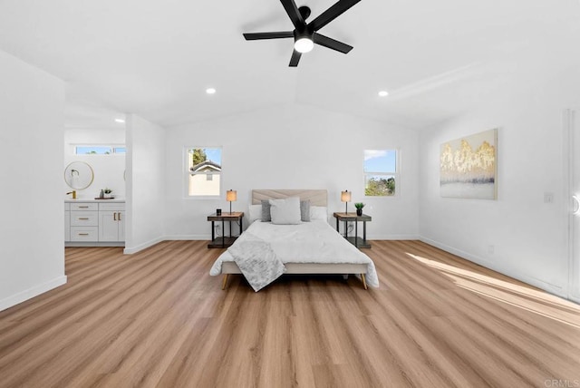 bedroom with multiple windows, vaulted ceiling, and light hardwood / wood-style flooring