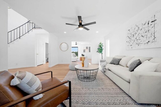 living room with hardwood / wood-style flooring and ceiling fan