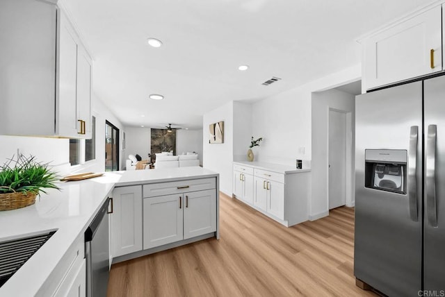 kitchen featuring ceiling fan, light wood-type flooring, white cabinets, and appliances with stainless steel finishes