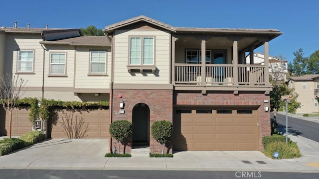 view of front facade with a balcony and a garage