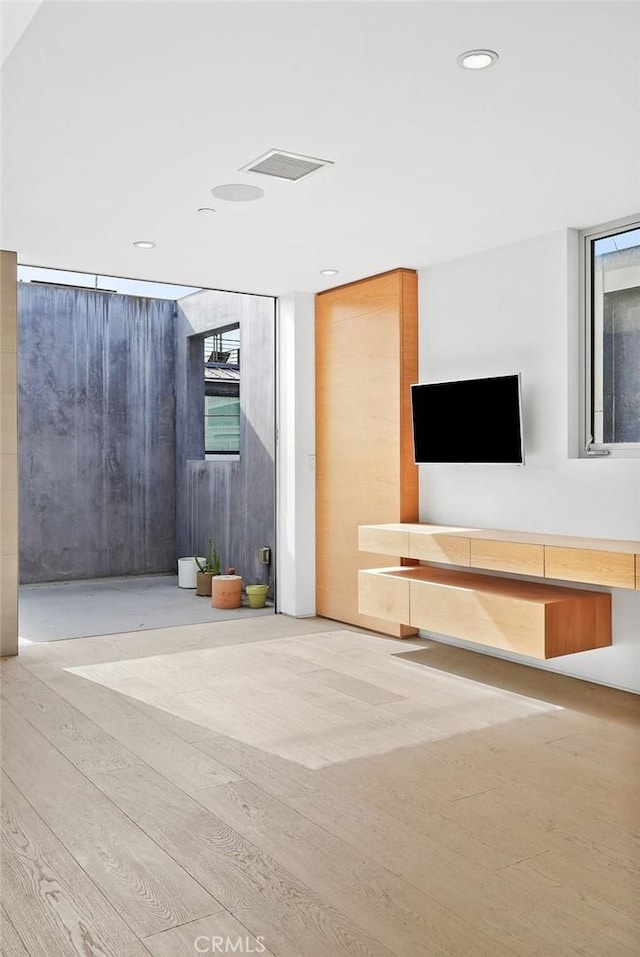 unfurnished living room featuring light hardwood / wood-style flooring