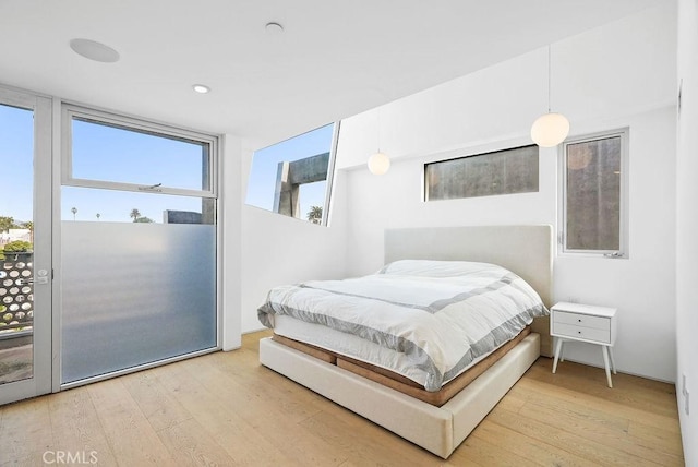 bedroom featuring hardwood / wood-style flooring and access to outside