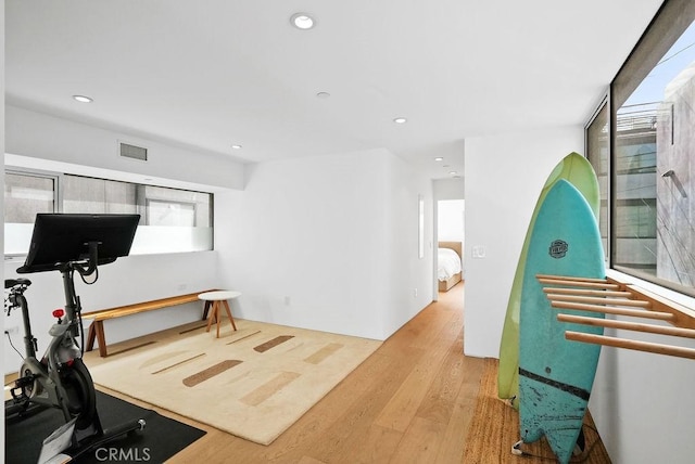 exercise area with light hardwood / wood-style floors