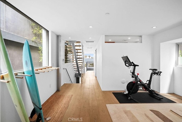 workout room with light hardwood / wood-style floors