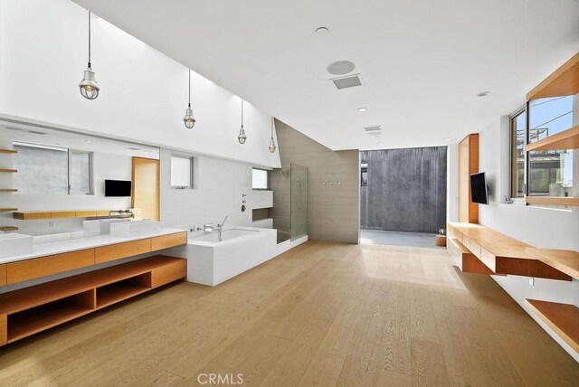 bathroom featuring vanity, hardwood / wood-style floors, and a bathtub