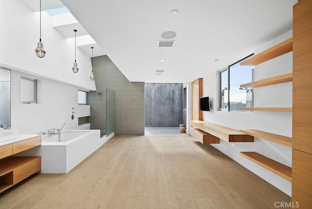 bathroom with vanity, a bathtub, and hardwood / wood-style flooring