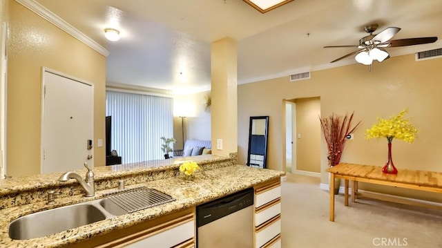 kitchen with dishwasher, sink, light stone counters, crown molding, and light carpet