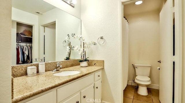 bathroom with vanity, tile patterned floors, and toilet