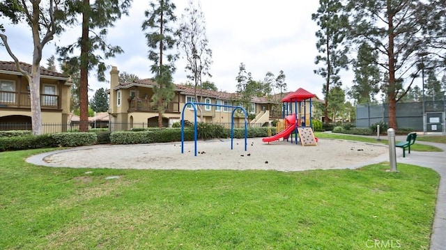 view of playground with a lawn