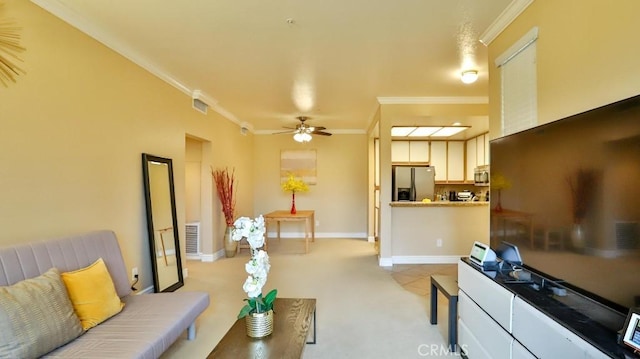 tiled living room with ceiling fan and ornamental molding