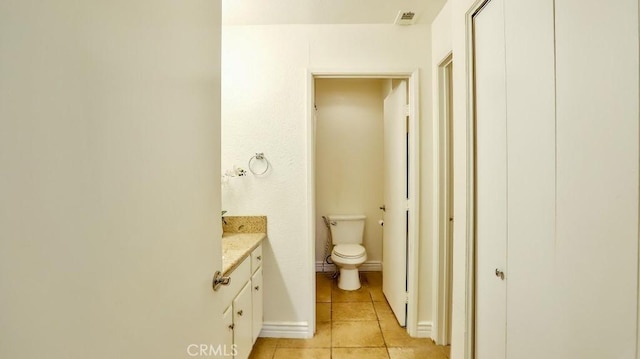 bathroom with tile patterned floors, vanity, and toilet