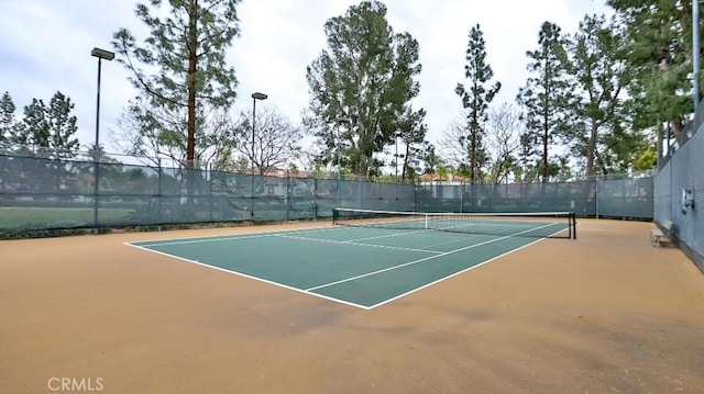 view of tennis court featuring basketball hoop