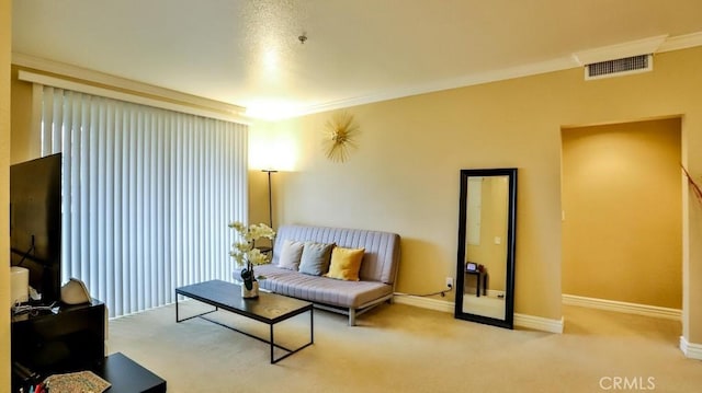 carpeted living room with ornamental molding