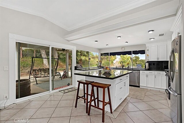7230 Sarsaparilla Dr, Corona, CA 92881 - kitchen featuring appliances with stainless steel finishes, dark countertops, light tile patterned floors, backsplash, and crown molding