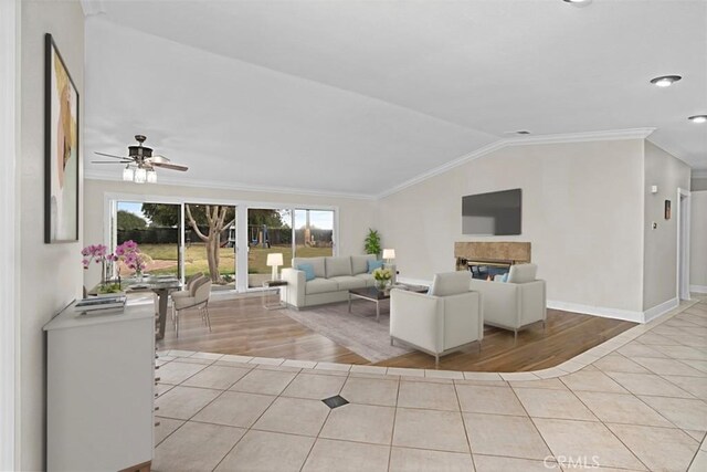 7230 Sarsaparilla Dr, Corona, CA 92881 - living room featuring light wood-style floors, lofted ceiling, ornamental molding, a ceiling fan, and a glass covered fireplace