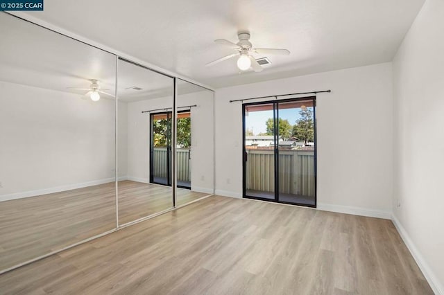 unfurnished bedroom with access to exterior, ceiling fan, and light hardwood / wood-style flooring