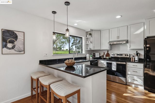 kitchen with sink, black appliances, kitchen peninsula, and white cabinets