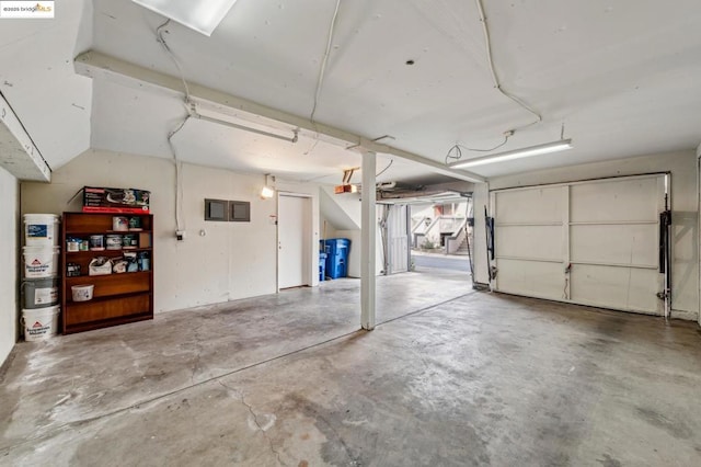 garage with a garage door opener and water heater