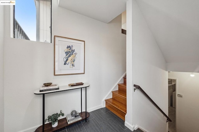 staircase featuring vaulted ceiling