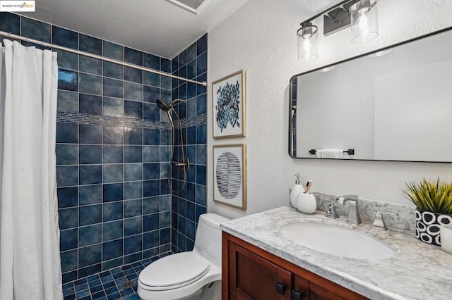 bathroom featuring vanity, curtained shower, a textured ceiling, and toilet