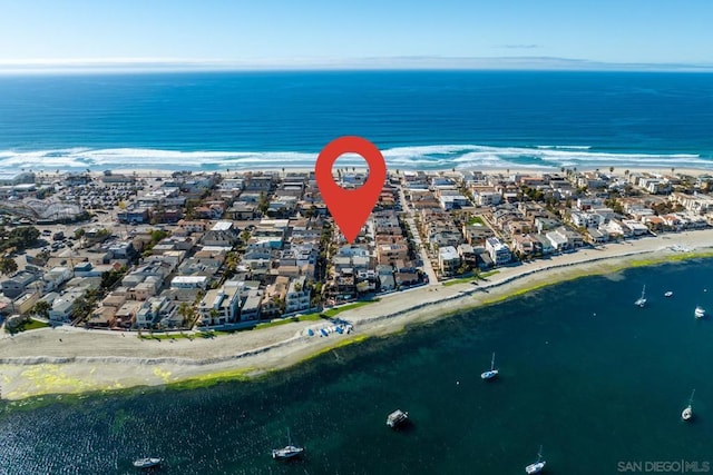 drone / aerial view featuring a view of the beach and a water view