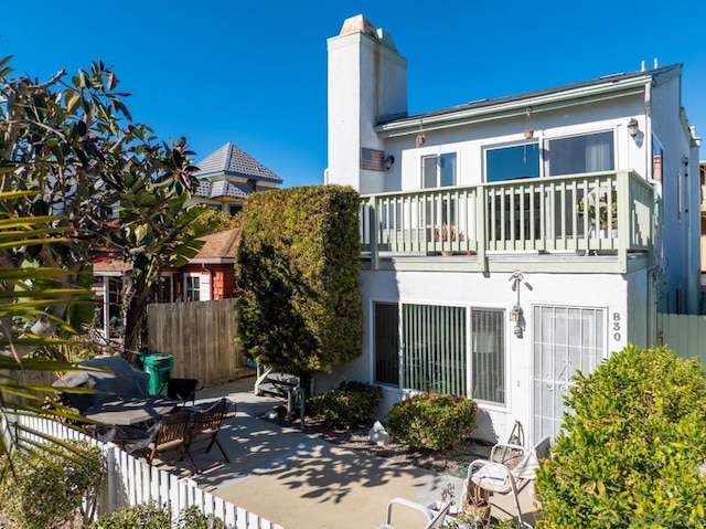 back of house with a patio and a balcony