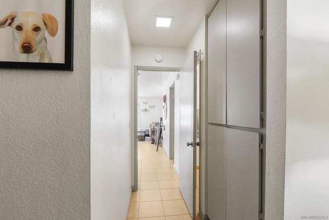 hall featuring light tile patterned floors