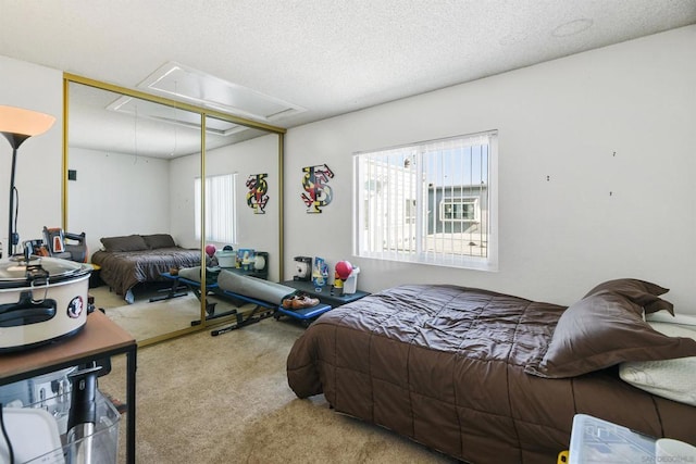 bedroom with a closet, a textured ceiling, and carpet