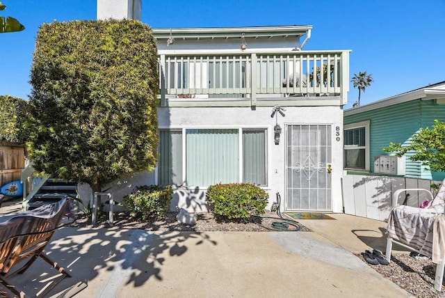 back of property with a patio area and a balcony