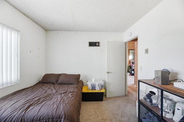 carpeted bedroom with a textured ceiling