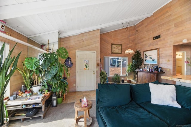 living room featuring wooden walls, beam ceiling, and carpet floors