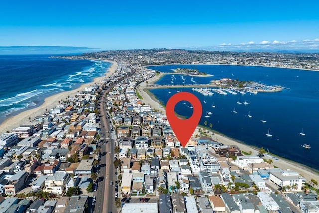 birds eye view of property with a view of the beach and a water view