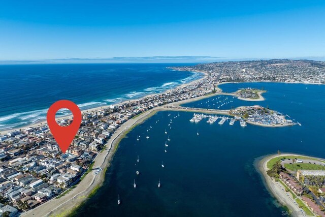 birds eye view of property with a beach view and a water view