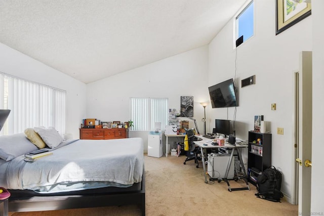 bedroom with high vaulted ceiling and carpet flooring