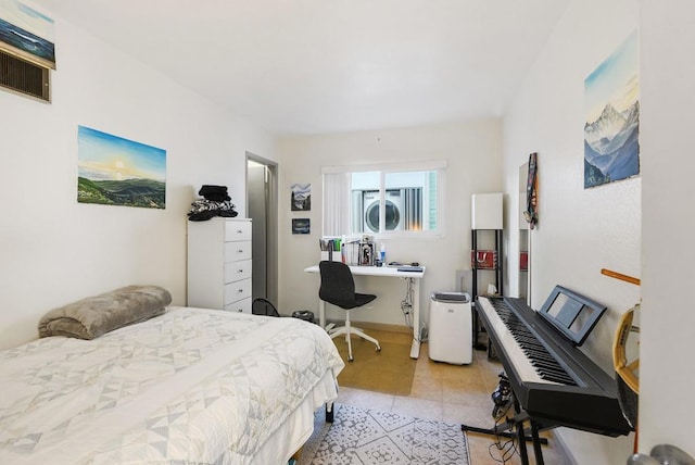 tiled bedroom featuring stacked washer / dryer