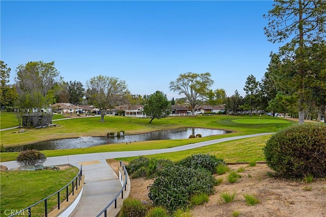 surrounding community featuring a water view and a lawn