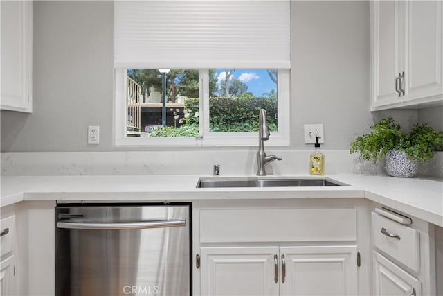 kitchen with white cabinetry, sink, light stone counters, and dishwasher