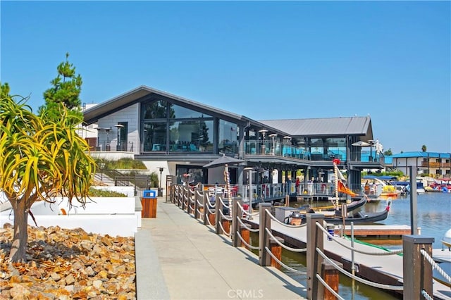 exterior space featuring a boat dock and a water view