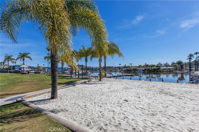 view of home's community featuring a water view and a yard