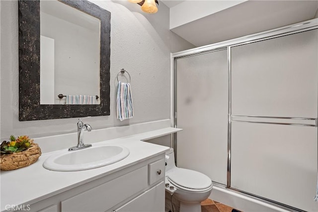 bathroom with vanity, toilet, and walk in shower