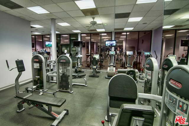 exercise room featuring a paneled ceiling and ceiling fan