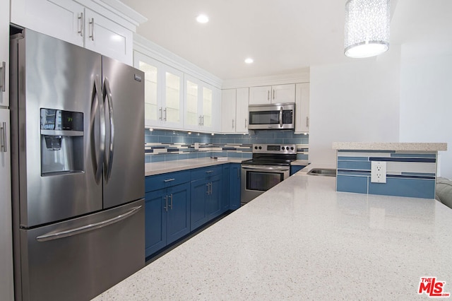 kitchen with white cabinetry, tasteful backsplash, stainless steel appliances, and blue cabinetry